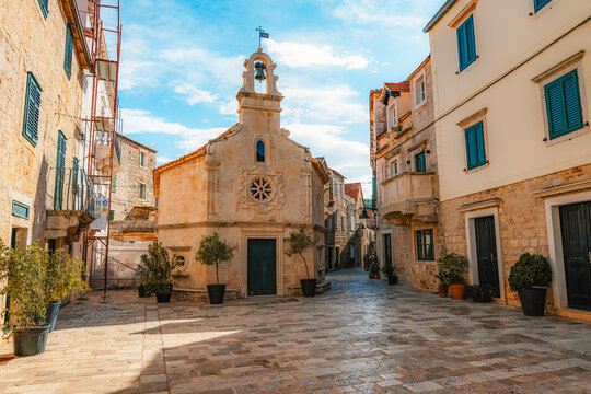 Jelsa town on Hvar island, with traditional Dalmatian stone architecture and boats moored in the harbor, Croatia.