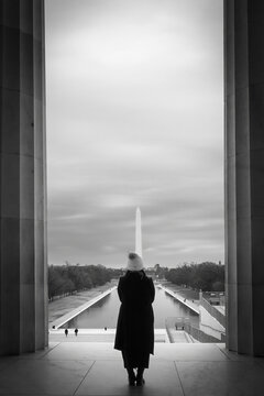 A person looking out at the Reflection pool in Washington DC