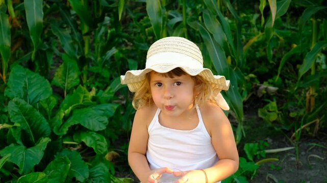 A child drinking water outside. Selective focus.