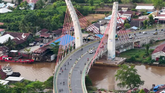 A view of Banjarmasin city and the Alalak River Bridge (or Basit Handil Bakti Bridge) in the late afternoon
