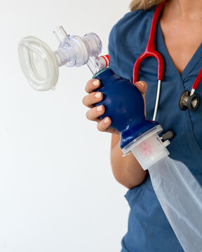 The doctor holds a manual breathing bag AMBU in his hands. It is intended for artificial ventilation of the lungs.