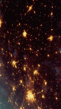 A bright night sky shows countless stars shining above Earth. The dark background highlights glowing points of light. This view captures the beauty of the cosmos from a distance.