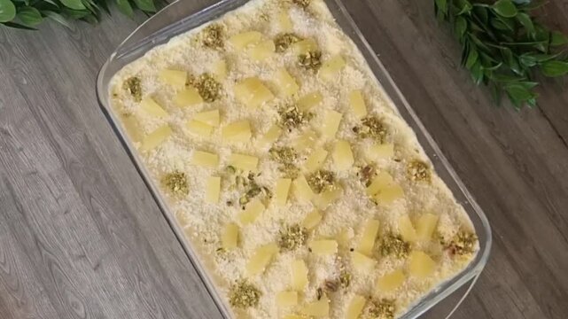 Decorating Pineapple Cake with Pistachios and Pineapple Chunks