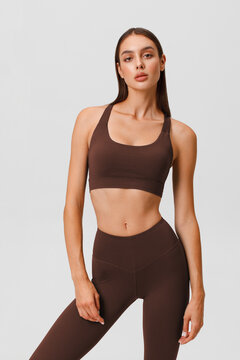 Athletic girl on the gray background. Fitness woman