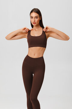Athletic girl on the gray background. Fitness woman