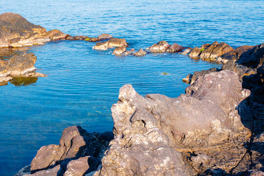 peaceful rock reflection in the sea water. calm summer vacation at the black sea. sunny weather