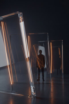 Leaning 3D glass sheets each lit by a single golden line