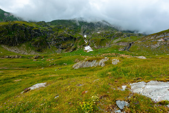 Romania mountain landscape in summer. scenic view of Fagaras ridge under overcast sky. rainy weather forecast background