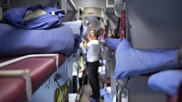 Passenger traveling in a modern sleeper train carriage, bunk beds prepared for journey