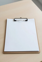 Fototapeta premium Blank white paper on a brown clipboard with a metal clip, resting on a light wooden desk, copy space for text