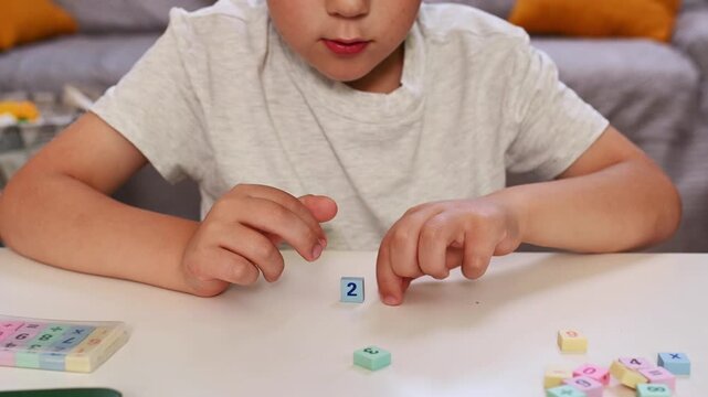 Child Learning Basic mathematics with Colorful Blocks, Early Education, STEM, Homeschooling, Preschool Math, Numeracy Skills, blurred closeup