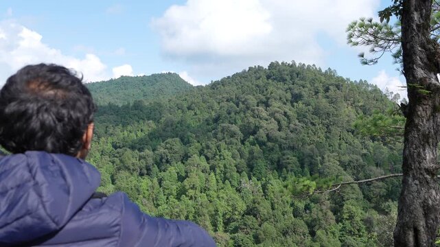 Man Looking Out Over Vast Green Woodland Canopy In Lower Himalayas