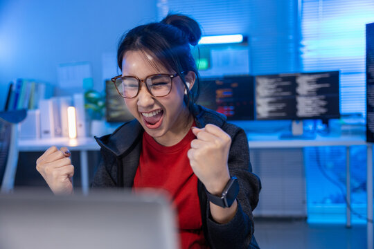 Programmer woman office computer code celebration glasses laptop monitor desk, cheerful programmer woman celebrating success office computer desk with code monitor, glasses, laptop, blue light