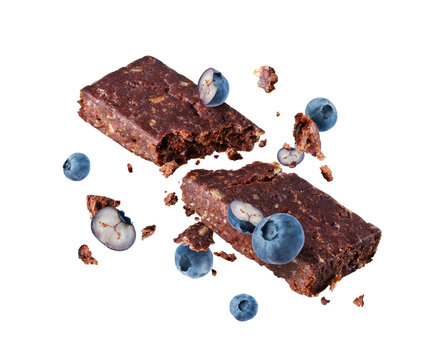 Broken chocolate energy bar with blueberries close-up in the air isolated on a transparent background