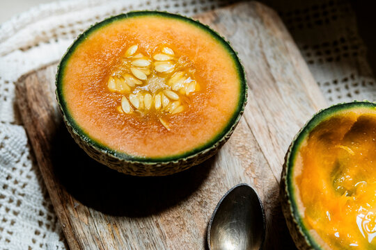 Cut Cantaloupe on Wooden Board During Indoor Setting