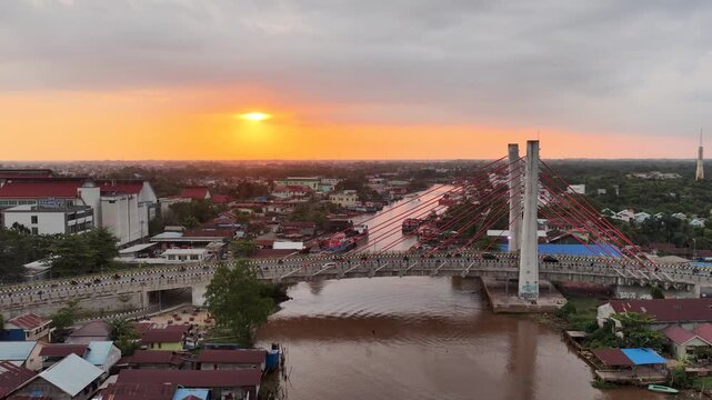 A view of Banjarmasin city and the Alalak River Bridge (or Basit Handil Bakti Bridge) in the sunset