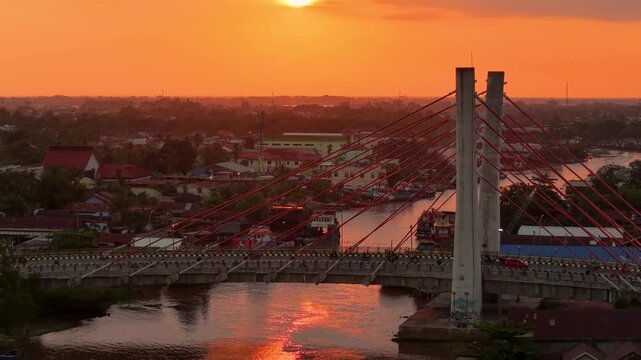 A view of Banjarmasin city and the Alalak River Bridge (or Basit Handil Bakti Bridge) in the sunset