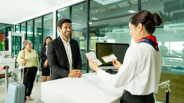 A traveler receives a boarding pass from airport staff during check-in highlighting professional assistance and a convenient passenger experience.