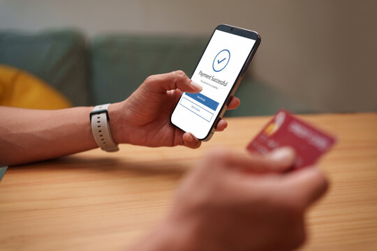 Man uses a smartphone and credit card for secure mobile banking and online payment, highlighting digital authentication, financial security, and convenient cashless transactions.