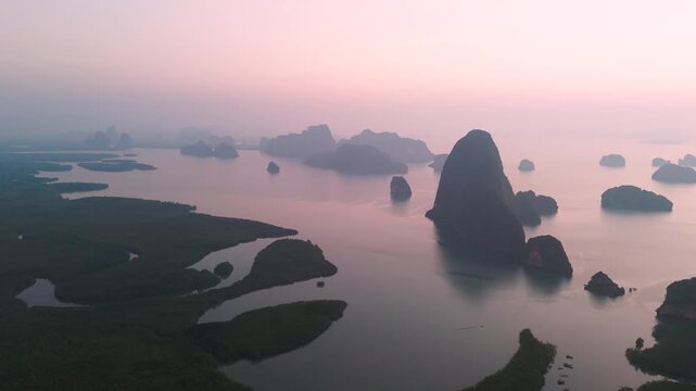Sunlight glows over the quiet tropical islands and calm ocean waters seen from the high Samet Nongshe Viewpoint in beautiful Phang nga Thailand
