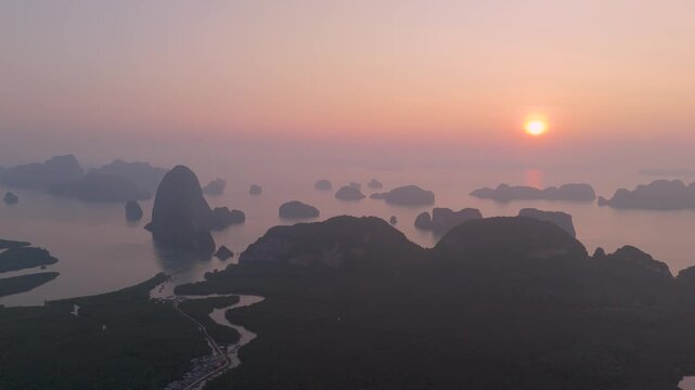 Golden morning light illuminates the tropical limestone islands and quiet mangrove rivers at the beautiful Samet Nongshe Viewpoint in Phang nga Thailand