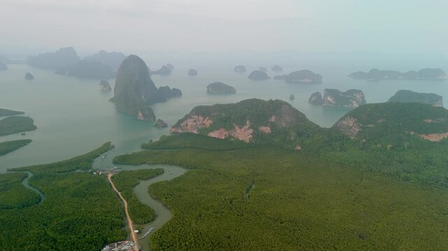 Stunning landscape of green mangrove forests meeting the ocean and limestone rock islands in Phang nga bay captured from Samet Nongshe Viewpoint in Thailand