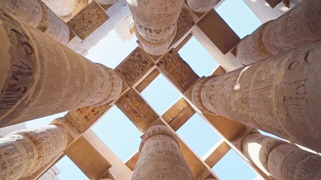 Pillars of the majestic temple of Karnak in Luxor, Egypt. Karnak Temple is dedicated to the temple complex of Ancient Egypt in honor of the god Amun-Ra, his wife Mut and son Khons. Thebes, Karnak.