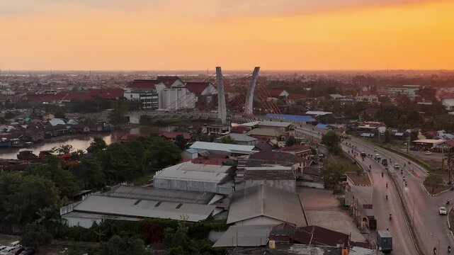 A view of Banjarmasin city and the Alalak River Bridge (or Basit Handil Bakti Bridge) in the sunset