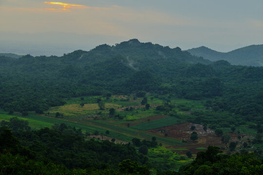 green mountain valley under moody cloudy sky