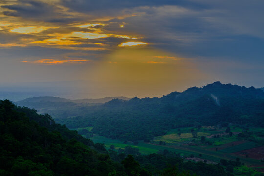 green mountain valley under moody cloudy sky