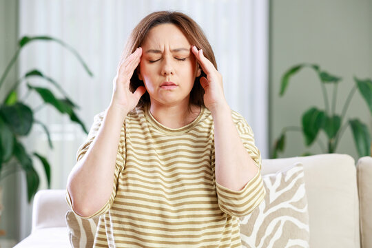 Woman massaging temples because of headache