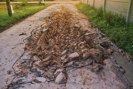 cracked concrete road with heavy vehicle damage