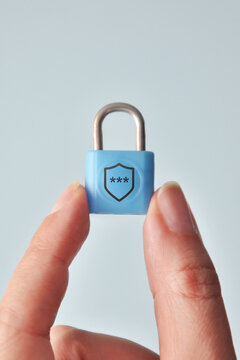 Blue padlock with shield symbol. Cybersecurity and data protection concept