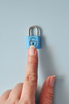 Finger touching blue padlock. Secure access and cybersecurity concept