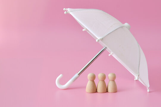 White umbrella protecting family figures. Family protection and security concept