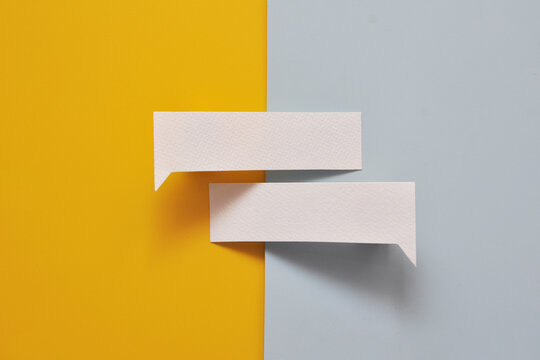 Two blank speech bubbles on contrasting background