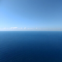 Fototapeta premium Minimalist Deep Blue Ocean Horizon Under a Clear Blue Sky, Clean Seamless Seascape with Calm Symmetrical Composition