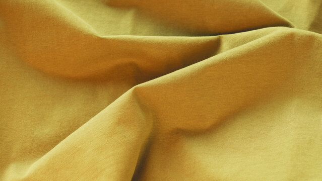Macro vibrant yellow fabric texture background with selective focus, soft folds, weave patterns, and fine micro-fibers. Perfect for eco-friendly product placement, logo mockups, copy space for text.