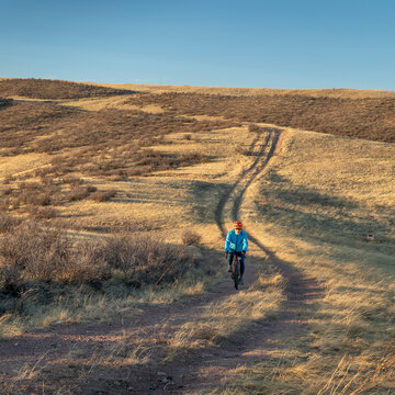 senior male cyclist is riding a gravel bike on a trail in Colorado foothills in early spring scenery, Soapstone Prairie Natural Area