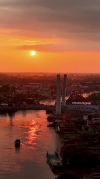 A view of Banjarmasin city and the Alalak River Bridge (or Basit Handil Bakti Bridge) in the sunset
