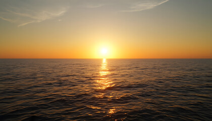 Fototapeta premium Brilliant Golden Sunset Over Calm Ocean Horizon with Warm Reflections Across the Water, Peaceful Evening Seascape