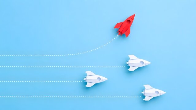 Startup innovation and disruptive technology symbolized by red paper rocket launching ahead of white competitors