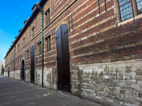 Antwerpen, Belgium, July 14, 2026 - Historic Hessenhuis brick facade with wooden doors along cobblestone street in Antwerpen, Belgi&euml;