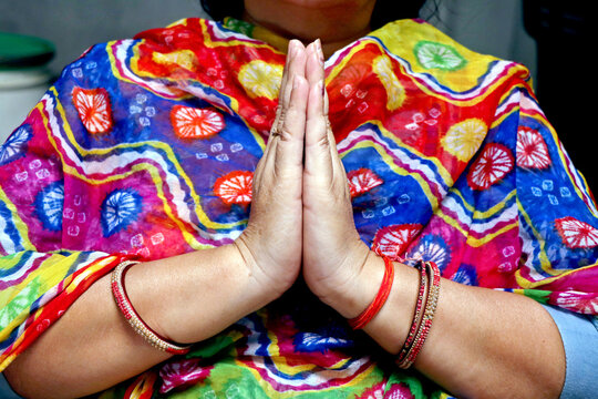Woman Showing Namaste Gesture with Folded Hands in Traditional Indian Style