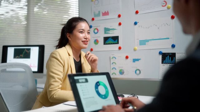 Business Analyst Presenting Data Charts in Office Meeting