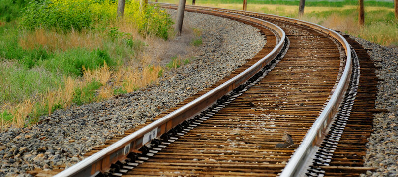 Railroad Rail Road Tracks Curving in the Distance Representing Travel and Unlimited Exploration
