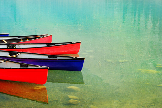 Red Canoes Docked at Moraine Lake in Banff National Forest in Alberta Canada