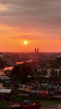 A view of Banjarmasin city and the Alalak River Bridge (or Basit Handil Bakti Bridge) in the sunset
