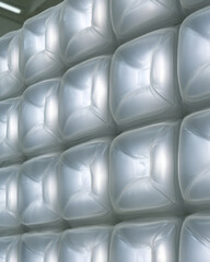 Obraz premium Silver Quilted Padded Wall Texture with Reflective Soft Cells and Copy Space