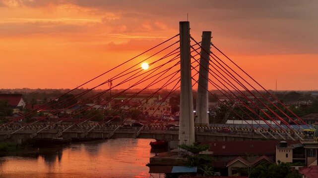 A view of Banjarmasin city and the Alalak River Bridge (or Basit Handil Bakti Bridge) in the sunset